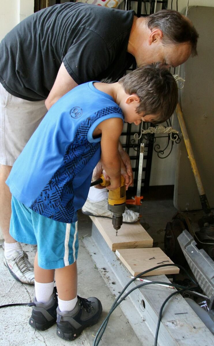 father-helping-his-son-with-woodwork